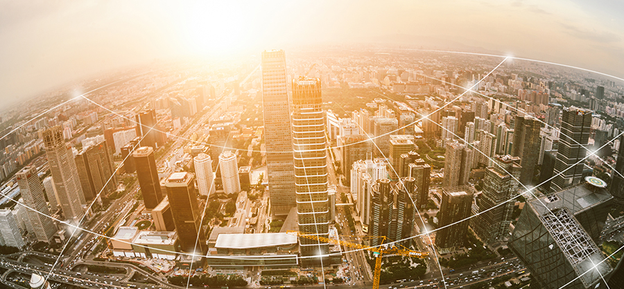 Cityscape at sunset with interconnected white lines symbolizing global communication and digital connectivity.