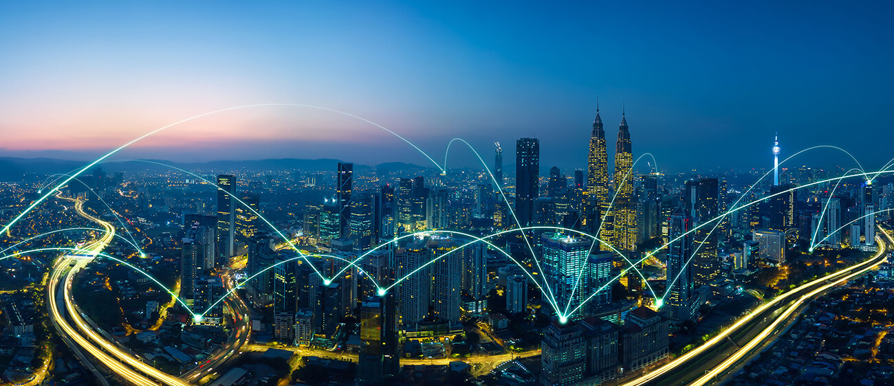 City skyline at night with glowing lines symbolizing digital connectivity and global communication.