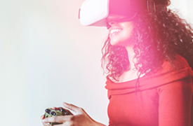 A young woman smiles with a VR headset on